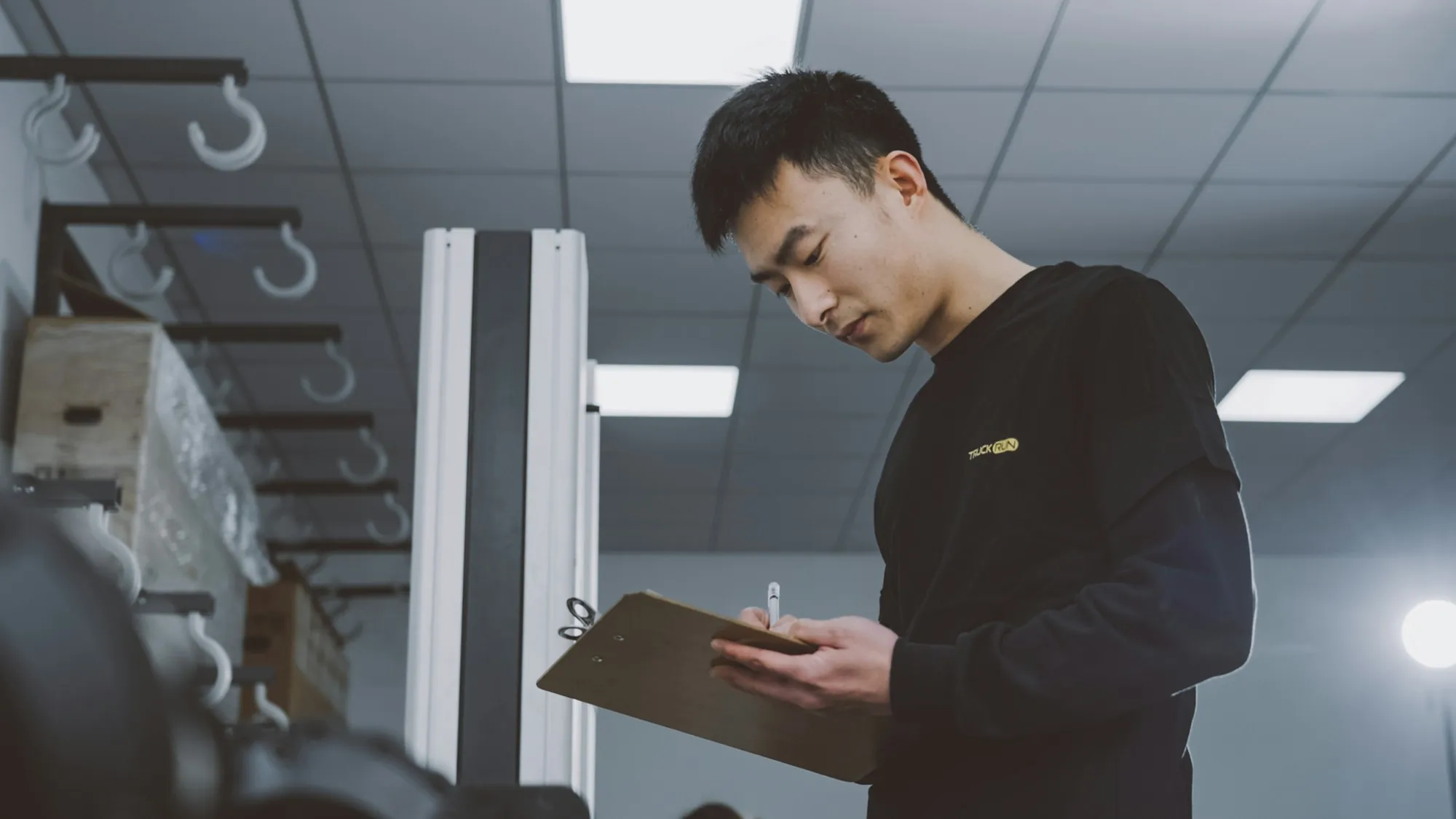 Electrician holding a clipboard while checking a job list