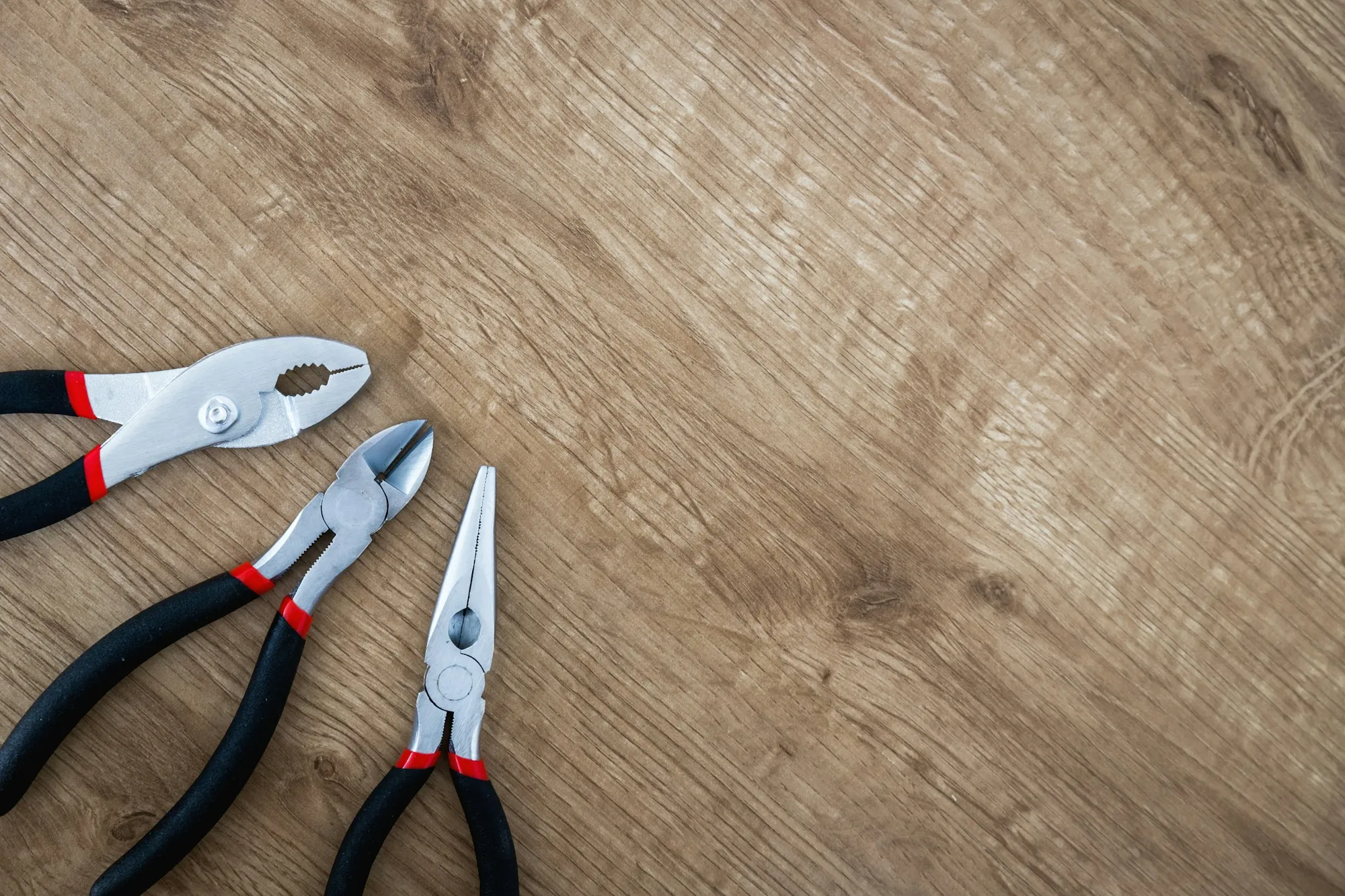 Assortment of electrician hand tools on a work surface
