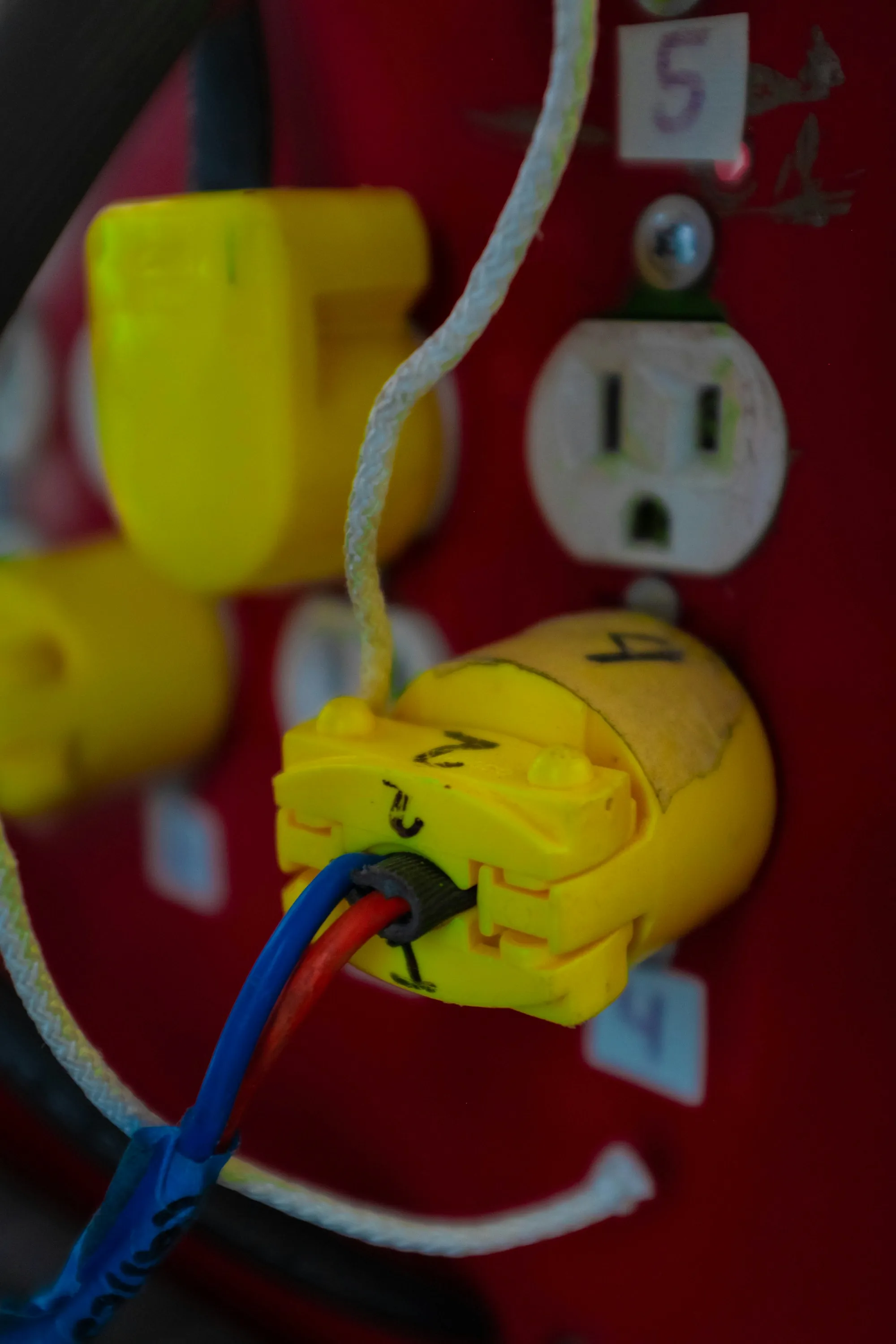 Plug connected to a red wall receptacle